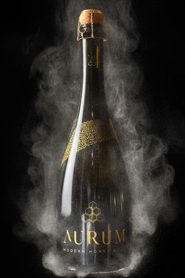 A bottle of AURUM vintage Sparkling Rose first release with smoke