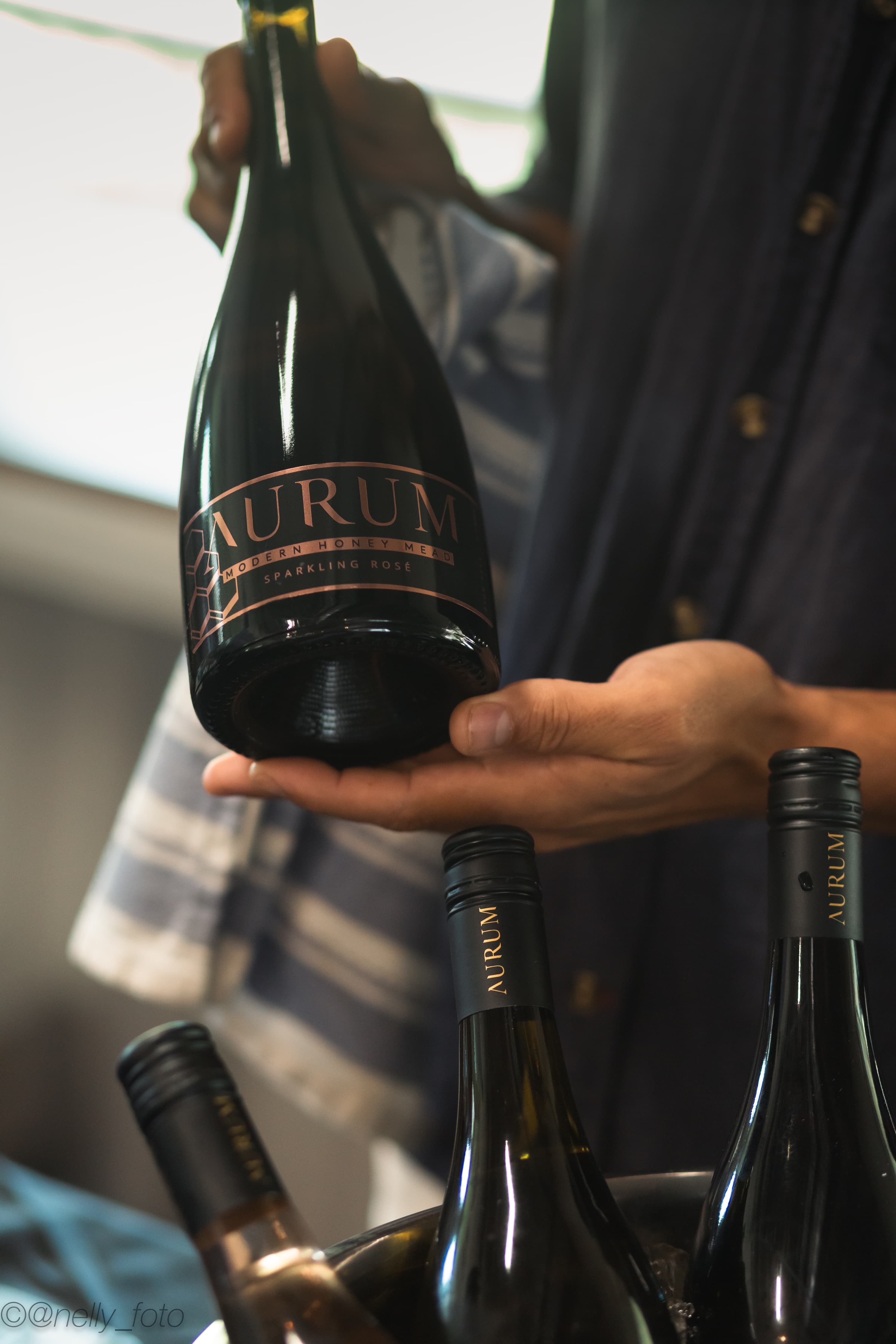 Winemaker holding a bottle of Aurum sparkling rose